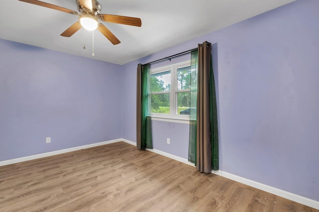 unfurnished room with light wood-type flooring and ceiling fan