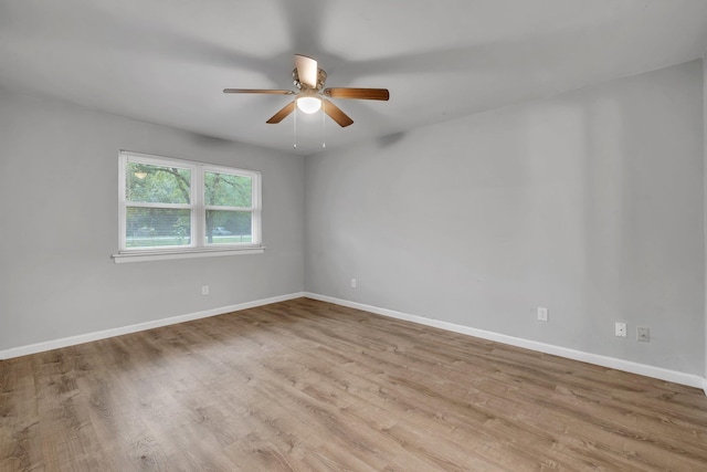 spare room featuring light wood-type flooring and ceiling fan