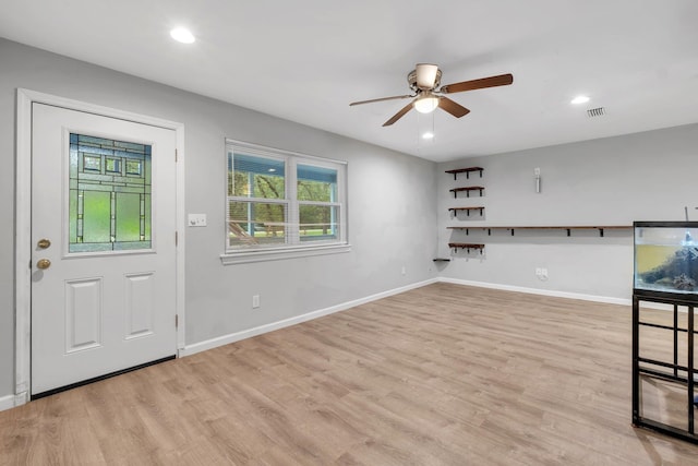 foyer entrance featuring ceiling fan and light wood-type flooring