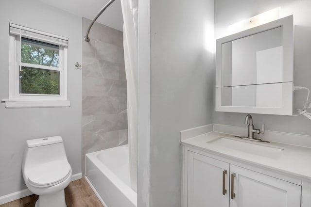 full bathroom featuring toilet, tiled shower / bath, vanity, and hardwood / wood-style flooring