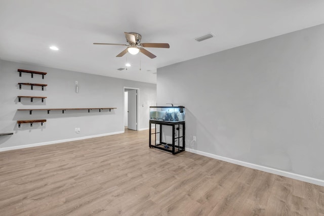 living room with ceiling fan and light hardwood / wood-style flooring