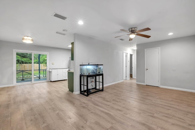 living room featuring ceiling fan and light hardwood / wood-style flooring