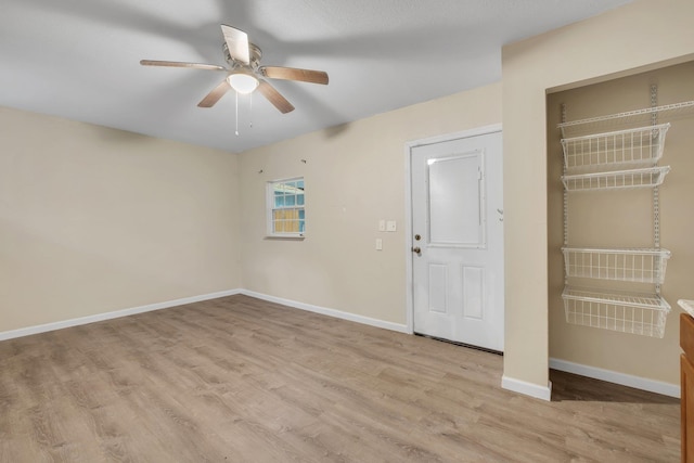 unfurnished bedroom with light wood-type flooring, ceiling fan, and a closet