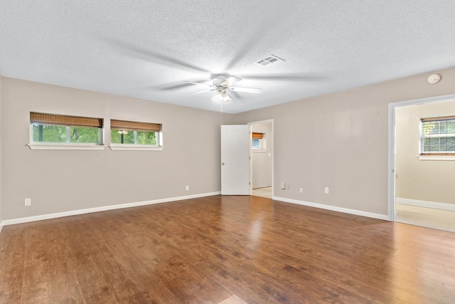 unfurnished room with a textured ceiling, wood-type flooring, and ceiling fan