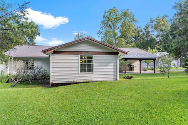 back of house with a gazebo and a yard