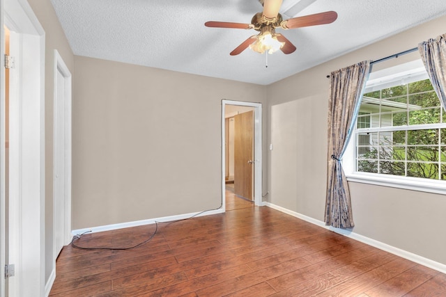 unfurnished bedroom with hardwood / wood-style floors, a textured ceiling, and ceiling fan