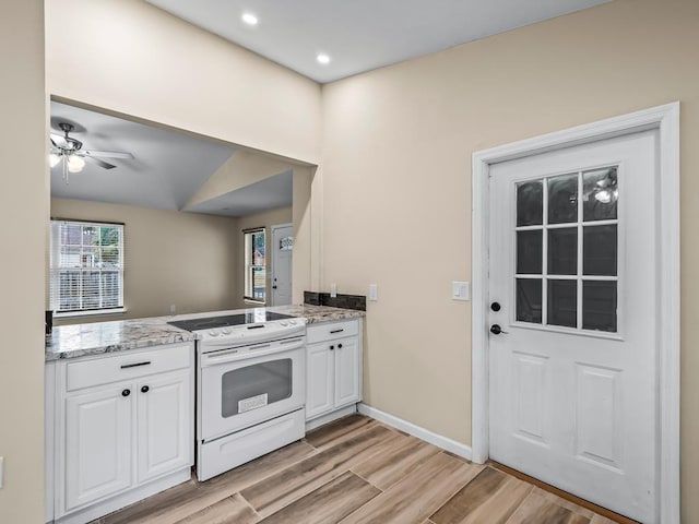 kitchen with light wood-type flooring, electric range, white cabinetry, and ceiling fan