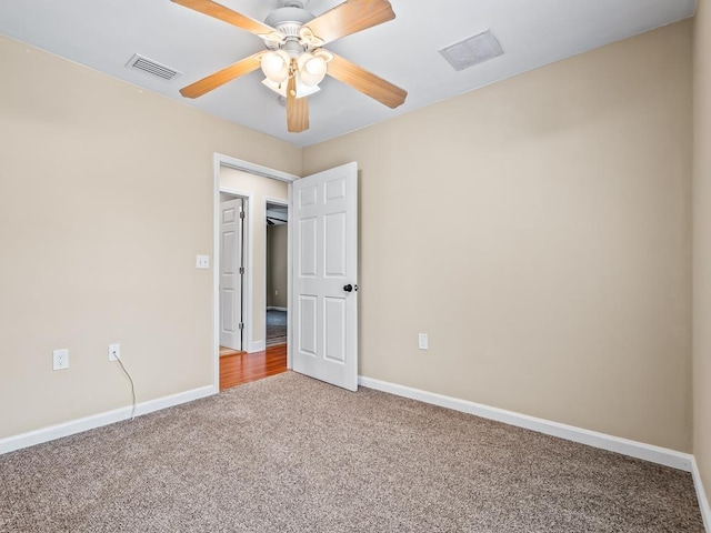 empty room with ceiling fan and carpet floors