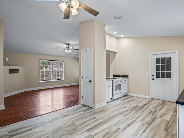 unfurnished living room featuring ceiling fan, vaulted ceiling, and light hardwood / wood-style flooring