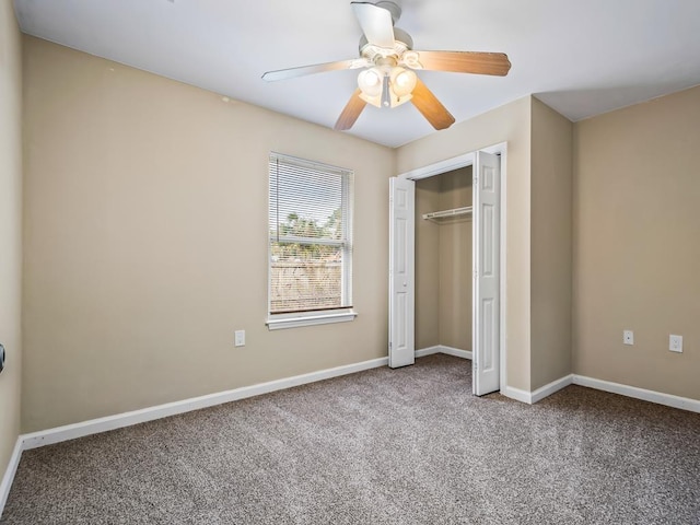 unfurnished bedroom with carpet, a closet, and ceiling fan