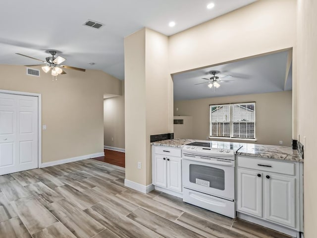 kitchen with ceiling fan, light hardwood / wood-style floors, lofted ceiling, electric stove, and white cabinets