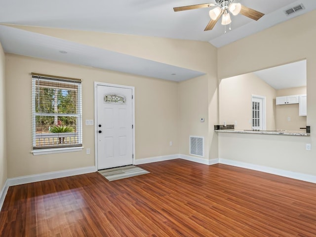 foyer featuring ceiling fan, dark wood-type flooring, and lofted ceiling