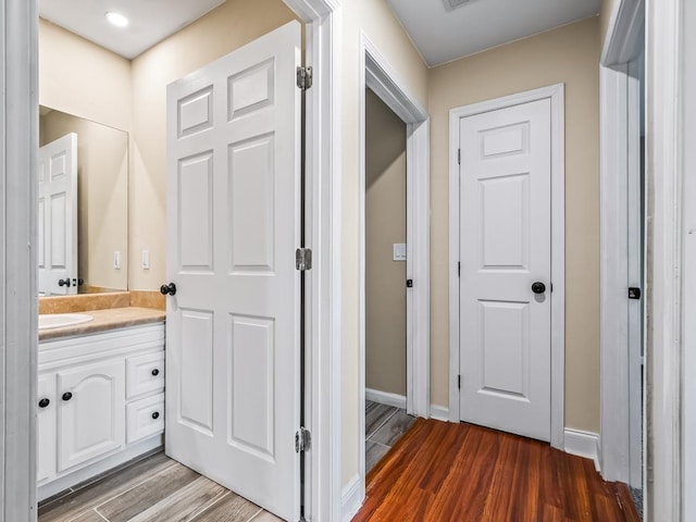 bathroom with hardwood / wood-style floors and vanity