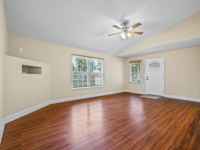 interior space featuring dark hardwood / wood-style flooring, vaulted ceiling, and ceiling fan