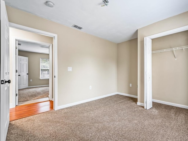 unfurnished bedroom with hardwood / wood-style flooring and a closet