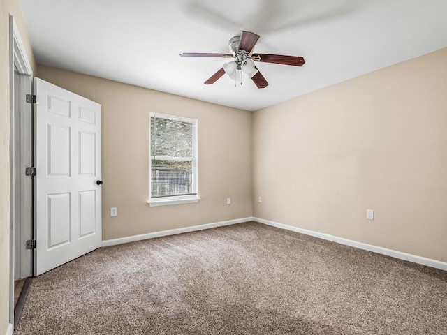 unfurnished room featuring ceiling fan and carpet floors