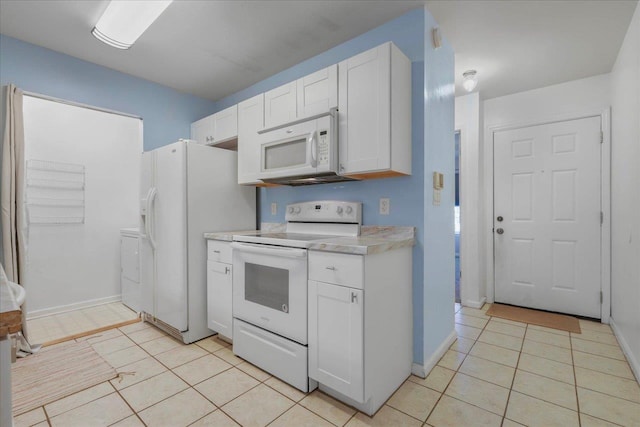 787 E Timberwood Cir, Tallahassee, FL 32304 - kitchen featuring white appliances, light countertops, white cabinetry, light tile patterned floors, and washer / dryer