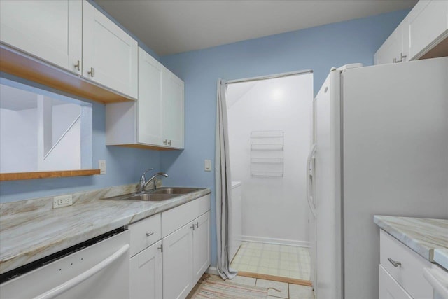 787 E Timberwood Cir, Tallahassee, FL 32304 - kitchen featuring white appliances, a sink, light floors, and white cabinetry