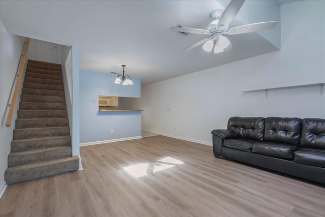 787 E Timberwood Cir, Tallahassee, FL 32304 - living area with wood finished floors, stairway, baseboards, and a chandelier