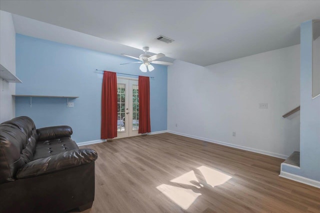 787 E Timberwood Cir, Tallahassee, FL 32304 - unfurnished living room with baseboards, wood finished floors, and a ceiling fan
