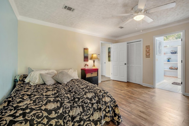 9025 Buck Lake Rd, Tallahassee, FL 32317 - bedroom with wood finished floors, a textured ceiling, ceiling fan, ornamental molding, and baseboards