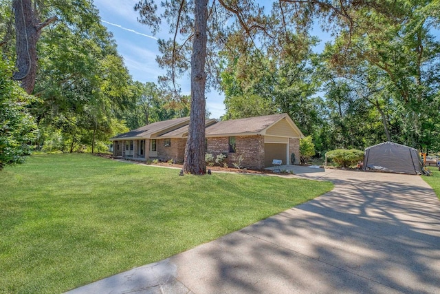9025 Buck Lake Rd, Tallahassee, FL 32317 - single story home with concrete driveway, a garage, a front yard, and brick siding