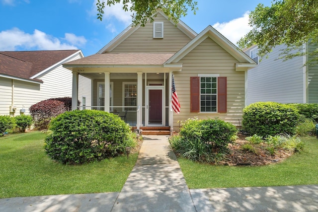 3248 Newberry Blvd, Tallahassee, FL 32311 - view of front of house with a front lawn, a shingled roof, and a porch