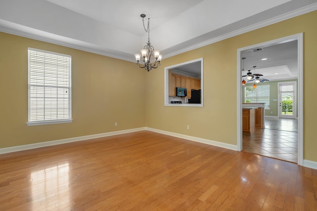 3248 Newberry Blvd, Tallahassee, FL 32311 - spare room featuring a raised ceiling, a chandelier, baseboards, ornamental molding, and light wood finished floors