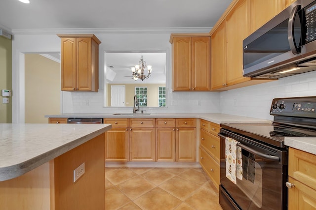3248 Newberry Blvd, Tallahassee, FL 32311 - kitchen featuring stainless steel microwave, black electric range, a sink, a chandelier, and decorative backsplash