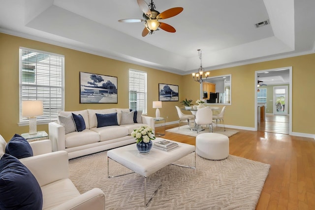 3248 Newberry Blvd, Tallahassee, FL 32311 - living area with a raised ceiling, ceiling fan, a chandelier, and light wood-style floors