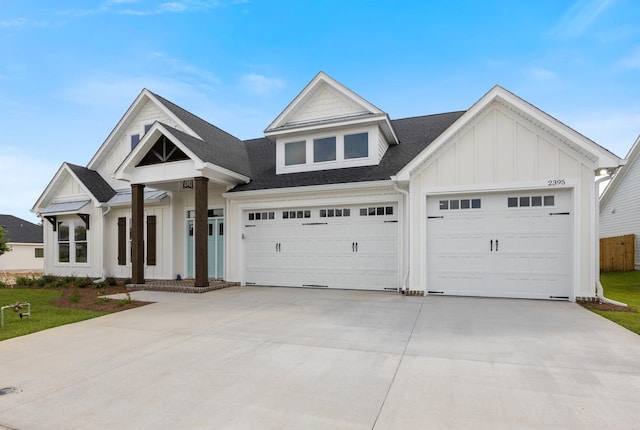 view of front facade with board and batten siding, concrete driveway, a shingled roof, and an attached garage