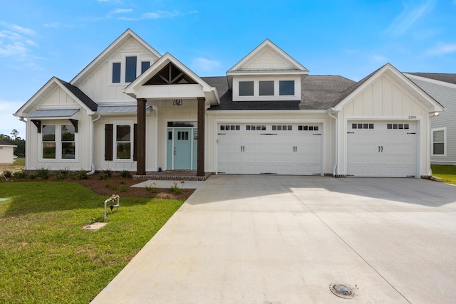 view of front facade featuring an attached garage, a standing seam roof, a front lawn, and board and batten siding