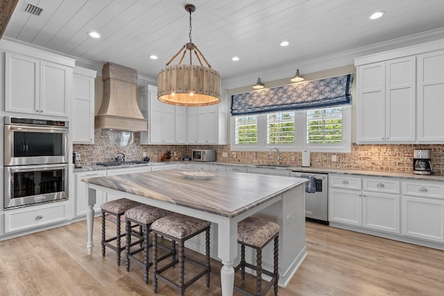 2845 NE Cherry Lake Cir, Pinetta Madison County, FL 32350 - kitchen with stainless steel appliances, custom range hood, a sink, a kitchen bar, and recessed lighting