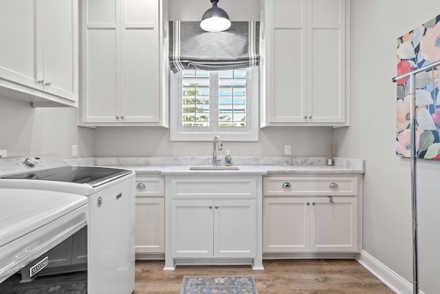 2845 NE Cherry Lake Cir, Pinetta Madison County, FL 32350 - clothes washing area featuring cabinet space, separate washer and dryer, and light wood finished floors