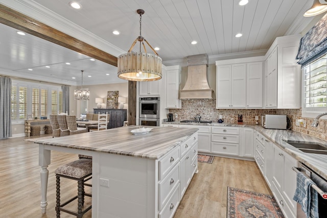 2845 NE Cherry Lake Cir, Pinetta Madison County, FL 32350 - kitchen with a sink, premium range hood, stainless steel appliances, crown molding, and a chandelier