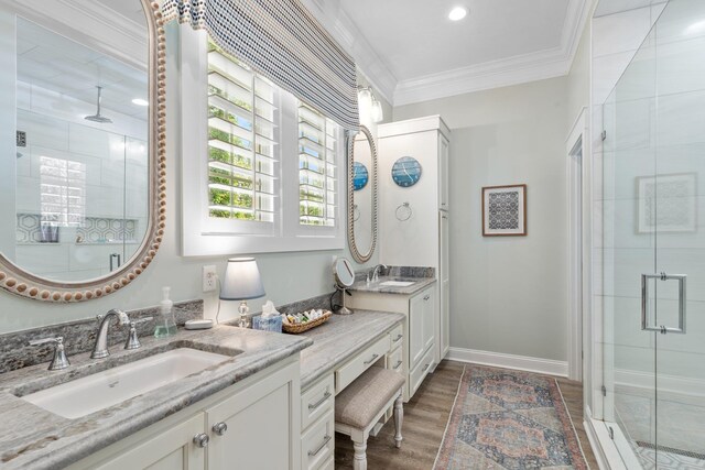 2845 NE Cherry Lake Cir, Pinetta Madison County, FL 32350 - bathroom with a shower stall, crown molding, two vanities, wood finished floors, and baseboards