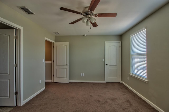 unfurnished bedroom featuring ceiling fan and carpet