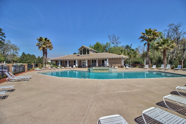 view of pool featuring a hot tub and a patio area