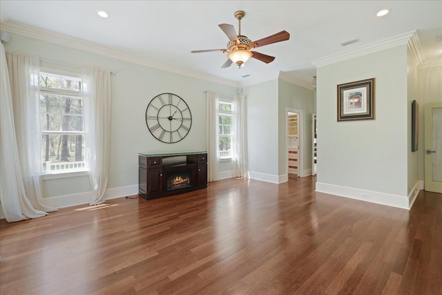 3621 Moody Trl, Tallahassee, FL 32309 - unfurnished living room featuring wood finished floors, a warm lit fireplace, ceiling fan, baseboards, and crown molding