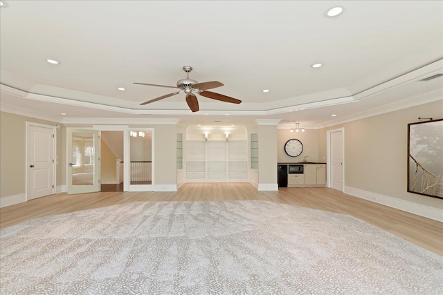 3621 Moody Trl, Tallahassee, FL 32309 - unfurnished living room with a raised ceiling, ornamental molding, light wood-type flooring, a ceiling fan, and recessed lighting