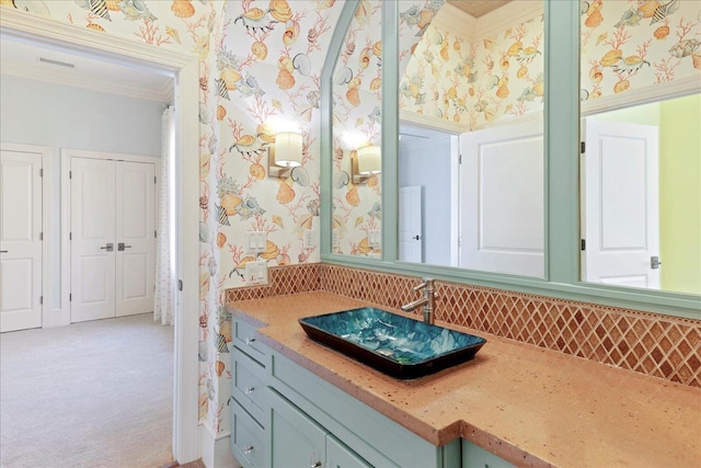 3621 Moody Trl, Tallahassee, FL 32309 - bathroom with wallpapered walls, ornamental molding, vanity, and backsplash