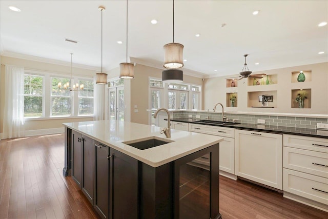3621 Moody Trl, Tallahassee, FL 32309 - kitchen with wine cooler, a sink, crown molding, healthy amount of natural light, and recessed lighting