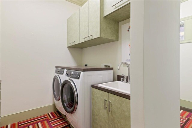3621 Moody Trl, Tallahassee, FL 32309 - washroom with cabinet space, washer and dryer, and baseboards