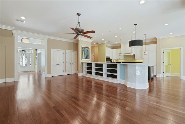 3621 Moody Trl, Tallahassee, FL 32309 - unfurnished living room featuring ceiling fan, wood-type flooring, crown molding, recessed lighting, and baseboards