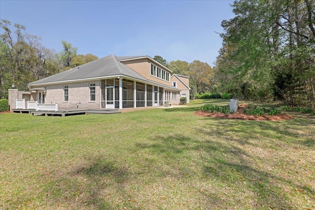 3621 Moody Trl, Tallahassee, FL 32309 - back of house featuring a sunroom, a yard, and a deck
