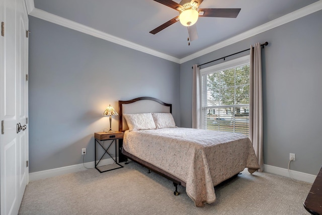 carpeted bedroom featuring ornamental molding and ceiling fan