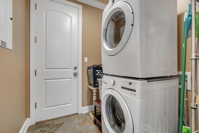 laundry room featuring stacked washer and clothes dryer