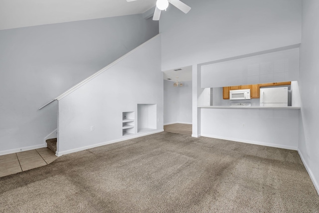 2738 W Tharpe St Unit 806, Tallahassee, FL 32303 - unfurnished living room with carpet flooring, high vaulted ceiling, stairway, ceiling fan, and built in shelves