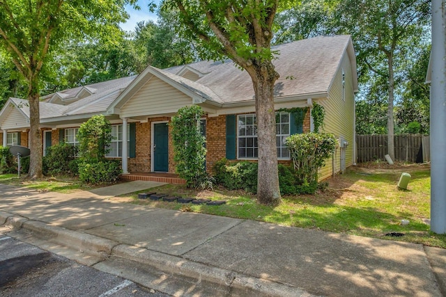 2738 W Tharpe St Unit 806, Tallahassee, FL 32303 - view of front facade featuring brick siding and a shingled roof