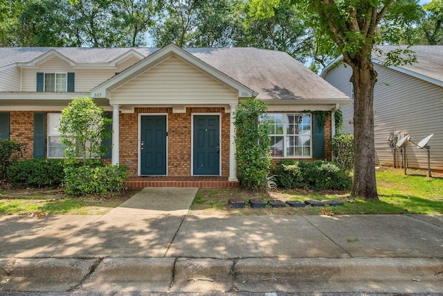 2738 W Tharpe St Unit 806, Tallahassee, FL 32303 - view of front of home with brick siding, roof with shingles, and a porch